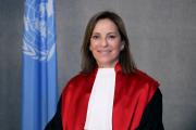 President Santana pictured in her judges robe next to an UN-flag